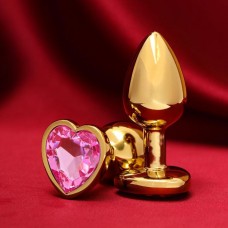 Золотистая анальная пробка с розовым кристаллом в форме сердца - 7 см.